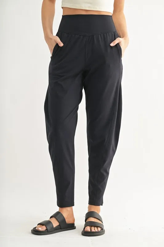 MONO B Flowbarrel High Waist Active Pants in black, featuring a lightweight, stretchy fabric with pockets for active wear.
