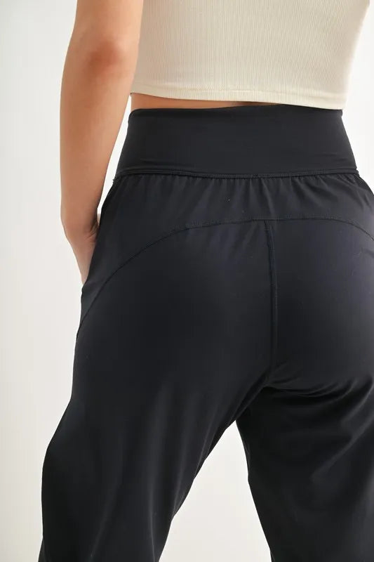 Back view of MONO B Flowbarrel High Waist Active Pants, showcasing their stretchy fabric and comfortable waistband.